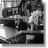Pixelated grayscale image of a figure in motion with indistinct background elements.