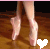Pixelated image of two ballet shoes on a wooden floor with a white heart symbol in the corner.