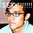 Pixelated close-up of a person with light skin, dark hair, and glasses wearing a light blue shirt against a blurred background.