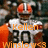 Pixelated image of a character with red eyes and metallic helmet, wearing white and orange outfit with 'Kellen' text above black number 20.