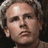 Pixelated portrait of a person with light brown hair against a dark background, set on an orange field with yellow text reading Art Garfunkel, CATCH-22, and Natalie.