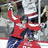 A hockey player in a red jersey with blue pants holds a stick, while another player in black gear skates nearby; the bottom shows a white jersey with 'MALKIN' and number 71.
