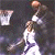 Animated basketball scene showing two players in white jerseys, one shooting a ball toward a hoop against dark background.