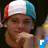 A person wearing a red-white-blue striped cap with hand near chin, blue square icons showing 'F', 'Y', 'a', 'n', '3' in sequence.