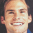 Pixelated image of a smiling person with short hair on the left, next to green text reading 'OriginalIcons.com' on a dark background.