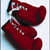 Static pixelated icon of two red boxing gloves with black accents on a light blue and white gradient background.