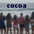 Group of people standing on beach with arms linked, text 'cocoa beach' above and '07' below, pixelated style.