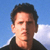 Static pixelated image of a person's face and upper shoulders against a blue sky background with white clouds, rendered in low-resolution 256x256 pixels.