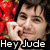 Pixelated image of a person holding a red object with visible text 'Hey Jude' at the bottom.