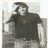 Four grayscale show a person in different poses: standing with arms outstretched, hand on forehead, and two close-ups of the face