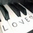Pixelated piano keys with partial text overlay and red pixel-art lyrics on black background.