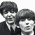 Two pixelated figures in grayscale, one with dark hair and a tie, the other with lighter hair, both facing forward against a white background.