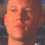 Four identical pixelated headshots of a light-skinned person with short hair arranged in a , each showing a neutral expression against a dark background
