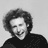 Black-and-white pixelated static image of a person with curly hair wearing dark clothing against a light background, rendered in low-resolution 48x48 pixels with visible dithering and anti-aliasing artifacts.