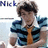 Pixelated image of a person with dark curly hair wearing a blue jacket, white shirt, and orange tie, with partial text 'Nick' visible above.