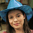 A static image shows a person wearing a blue pointed hat against a pink background with yellow text reading 'love' and 'Carly'.