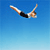 Pixelated static image of a person in mid-air diving pose against blue gradient background with visible anti-aliasing and dithering effects.