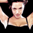Pixelated static image of a person with light skin tone, dark hair styled up, and visible upper chest against black background with white wing-like shapes on sides.