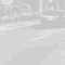 Black-and-white animated sequence showing a person running across a road with vehicles and buildings in the background.