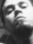 Four grayscale and sepia-toned show a person's face in different poses with varying lighting, from upward gaze to downward tilt
