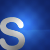 A pixelated white 'S' shape on a blue gradient background with a bright light effect on the right side.
