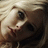 A blonde woman's face in a of four showing slight variations in head angle and expression