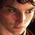 Pixelated close-up of a person's face with brown hair, light skin, and visible eyes and nose, cropped tightly on the upper face.