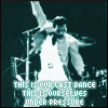 identical animated frames showing a person in a white suit with arms raised, standing behind a drum kit, with text at the bottom reading "THIS IS OUR LAST DANCE UNDER PRESSURE"
