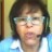Pixelated close-up of a person with short dark hair wearing light-colored glasses and a blue-and-white garment against a blurred background.
