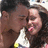 A pixelated image shows two people in close proximity with a black background and red text elements.