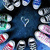 small, pixelated icons on a dark blue background with white heart symbols, featuring repeated patterns of stylized faces and objects in red, green, blue, and white