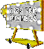 A yellow and white marquee-style sign with illuminated bulbs and text on a gray background, supported by two yellow legs with wheels.