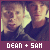 Two pixelated faces in profile view against a dark background, with text below reading 'DEAN + SAM' on a maroon strip.