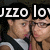 Two pixelated figures in formal attire with overlaid text reading "JIZZO love" against a dark background.