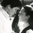 Black-and-white image of two people kissing, paired with text about the world's beauty.