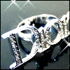 Animated silver ring with embedded crystals on a dark background with white lines, showing subtle motion in the ring's position and crystal reflections
