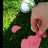 Pixelated image of a hand holding pink liquid with green background and white sphere, paired with pixelated text about heart replies.