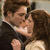 A couple in formal attire embraces closely, the man holding the woman as she leans into him with eyes closed.