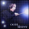Static buddy icon showing a person holding a glowing wand with text "OOH... SHINY" against a dark patterned background.