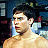 Pixelated static image of a person with dark hair and light skin, cropped to show shoulders up against a blue-toned background.
