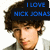 Pixelated image of a person with brown hair wearing a black cap displaying blue text reading 'I LOVE NICK JONAS' against a white background.