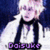 Pixelated image of a person with light hair and dark clothing against a blue background, featuring purple text at the bottom.