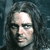 Pixelated close-up of a person with long dark hair against a dark blue background, showing partial facial features and light-colored skin tones.