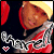Pixelated static icon featuring a cartoon character with brown skin, red hair, and a silver-and-red outfit against a dark background with yellow light effects.