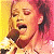 A pixelated contact sheet showing two frames of an animated icon featuring a singer with red hair holding a microphone on the left and green text reading "Original Icons .com" on the right against a dark background.