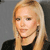 Static pixelated image of a person with long blonde hair wearing a black top against a gray background.