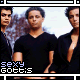 A pixelated image of a person in a black V-neck shirt with repeated text "sexy gottis" at the bottom left.
