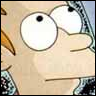 Close-up of a cartoon character's face with large white eyes, black pupils, and a slightly open mouth, wearing a patterned shirt.