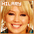 Four identical pixelated images of a smiling person with blonde hair, each labeled 'HILARY' in text above the head.