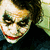 A pixelated image of a character with white face paint, dark eye makeup, and red lips in three distinct poses.